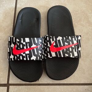 Nike Black Slides with Red Swoosh and Text Design